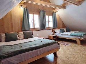 a bedroom with a bed and a couch in a room at Chalupa Bocza in Nižná Boca