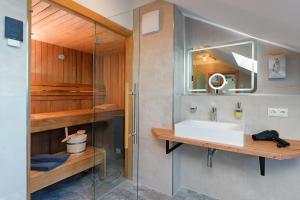 a bathroom with a sink and a mirror at Hotel Schluister Park in Carolinensiel