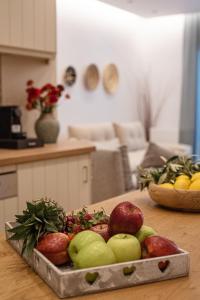 a tray of apples and other fruits on a table at Anasasmos House in Naxos Chora