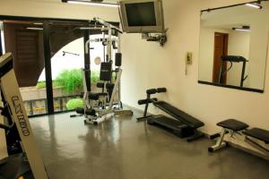 a gym with several tread machines and a tv at Belíssimo Flat em Pinheiros in Sao Paulo
