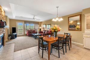 a dining room and living room with a table and chairs at StoneBridge Village Resort in Reeds Spring