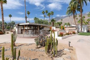 a restaurant with palm trees and cactuses in front of it at Mid-Century Palm Springs Bungalow with Patio! in Palm Springs