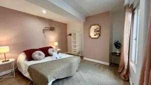 a bedroom with a bed and a window at Un goût de liberté in Nevers