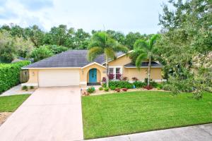 a house with a driveway and palm trees at Pet Friendly Pool Home in River Reach of Naples FL in Naples