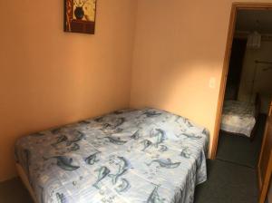 a bedroom with a bed with dolphins on it at maison vacances in Quézac +13 photos