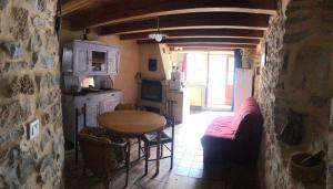 a kitchen with a table and a dining room at maison vacances in Quézac