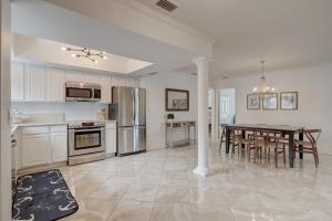 a kitchen with a table and a dining room at Pool Home Super Close To Vanderbilt Beach in Naples