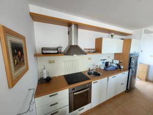 a kitchen with a sink and a refrigerator at Sun Village Villa Byala in Byala