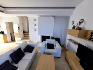 a living room with a couch and a fireplace at Sun Village Villa Byala in Byala