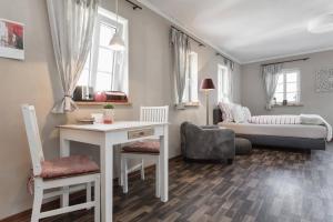 een woonkamer met een tafel en een bank bij Pension Adele - Ruhig, direkt am Elberadweg & Badesee mit Balkon in Dresden