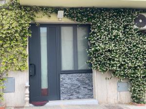 a black door on the side of a building at Sweetlove Spa in Terracina