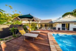 a house with a wooden deck and a swimming pool at Ninderry Manor-Spectacular Hinterland retreat in Ninderry