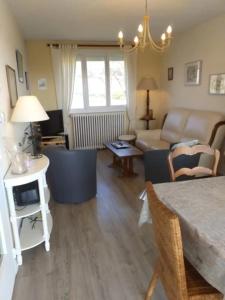 a living room with a couch and a table at La maison d'Ormancey in Mont-Saint-Jean