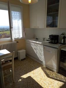 a kitchen with a sink and a stove top oven at La maison d'Ormancey in Mont-Saint-Jean
