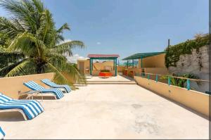a couple of lounge chairs sitting on a balcony at Numa Hotel Boutique in Playa del Carmen