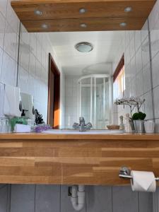 a bathroom with a sink and a large mirror at Engimyri Lodge in Akureyri