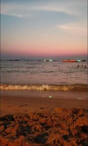 a view of the ocean at sunset at Grand Florida BeachFront Resort NaJomtien Pattaya in Na Jomtien