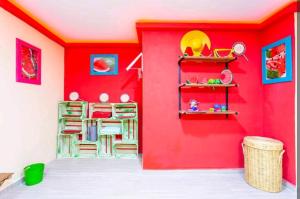 a room with a red wall with shelves at Numa Hotel Boutique in Playa del Carmen