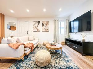 a living room with a couch and a flat screen tv at Hollywood Habitat - BR11-WH in Los Angeles