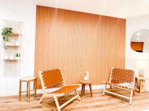 a room with two chairs and a striped wall at Hollywood Habitat - BR11-WH in Los Angeles