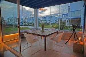 a dining room with a table and chairs on a balcony at AKS Home appart 2 - CABONEGRO in Cabo Negro