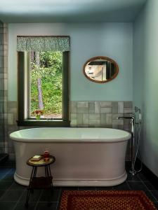 a bath tub in a bathroom with a window at Little Cat Lodge in Hillsdale