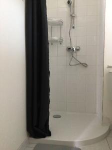 a shower with a black shower curtain in a bathroom at Maison Caroual Erquy 500m de la PLAGE in Erquy +18 photos
