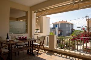 a patio with a table and chairs on a balcony at Nest Aegina Apartments in Perdika