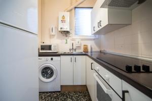 a kitchen with a washing machine and a sink at 31PAR1008 - Mediterranean style apartment in Barcelona