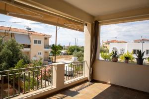a balcony with a view of a city at Nest Aegina Apartments in Perdika
