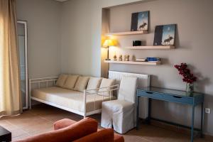 a living room with a couch and a table at Nest Aegina Apartments in Perdika