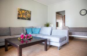 a living room with a couch and a coffee table at Nest Aegina Apartments in Perdika