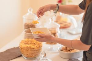 a woman eating food from a bowl on a table at Ancóramare in Stintino +32 photos