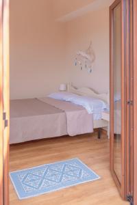 a bedroom with a bed and a mirror at Ancóramare in Stintino