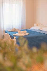 a room with two beds with towels on them at Ancóramare in Stintino