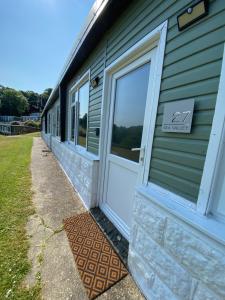 a front door of a house with a sign on it at 27 Sea Valley Chalet in Bucks Mills +18 photos