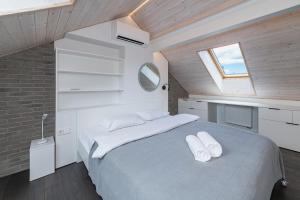 um quarto com uma cama com lençóis brancos e uma janela em Luxury 2 BD Apartment with terrace by Hostlovers em Kaunas