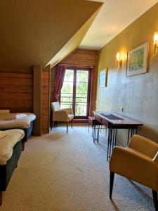 a room with two beds and a table and chairs at Green bear in Līgatne