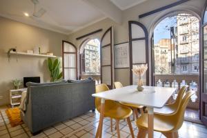 a living room with a table and a couch at P1PAR195 - Wonderfull aparment in Paralel in Barcelona