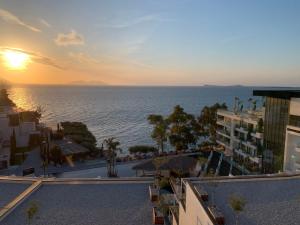 a view of the ocean at sunset from a hotel at Marina Chic Apartment in Vlorë