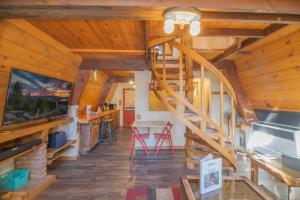 um quarto com uma escada num chalé com tectos em madeira em A-Frame of Mind - Nice cozy cabin great view to the outdoors and peaceful em Big Bear City