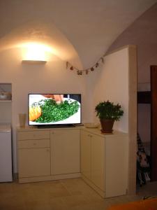 a living room with a flat screen tv on a counter at Ai Due Archi in Martina Franca