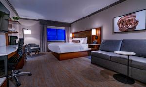 a hotel room with a bed and a couch at Grand Traverse Resort and Spa in Traverse City