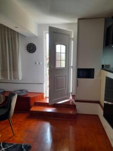 an empty living room with a door and a table at Apartman T and T in Ražanac