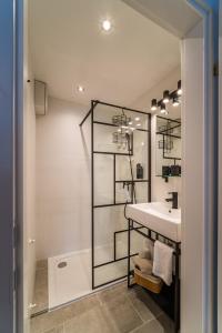 a bathroom with a sink and a mirror at Hotel Fuchs & Hase SELF CHECK IN in Rosegg