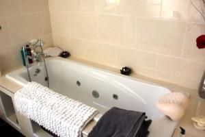 a bathroom with a bath tub with towels on it at Baile Go Deo. in Falcarragh