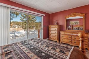 a bedroom with a bed and a dresser and a window at Boulder Bay Lakefront Getaway - Across the street from the lake and Boulder Bay Park! in Big Bear Lake