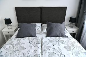 a bedroom with a large bed with two night stands at New and modern apartment BaRoNi in Split