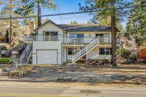 a large white house with a garage at Boulder Bay Lakefront Getaway - Across the street from the lake and Boulder Bay Park! in Big Bear Lake