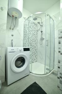 a washing machine in a bathroom with a shower at New and modern apartment BaRoNi in Split
